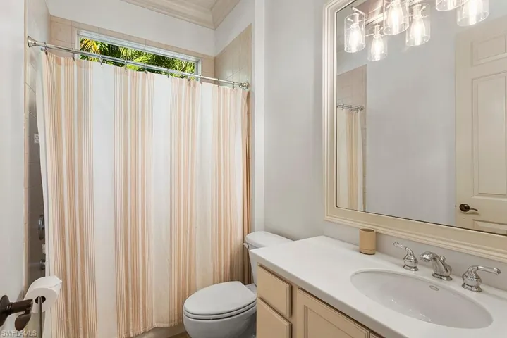 Full bathroom with vanity and a shower with shower curtain