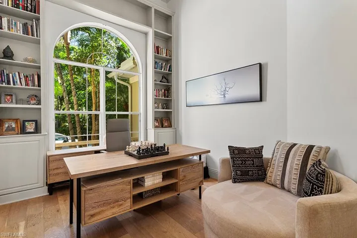 Sitting room with built in shelves and wood finished floors