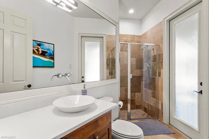 Bathroom featuring vanity and a stall shower