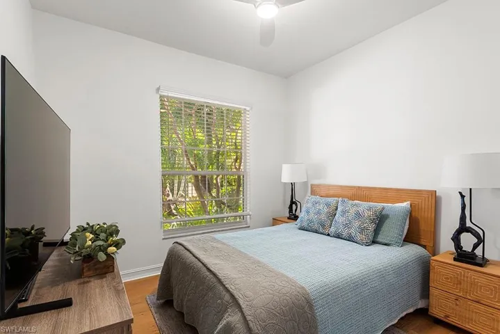 Bedroom featuring wood finished floors and a ceiling fan