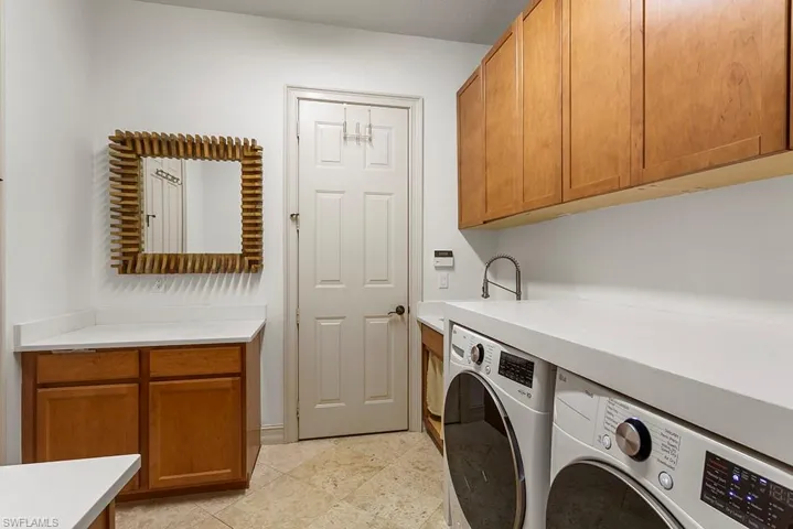 Laundry area featuring cabinet space and washer and dryer