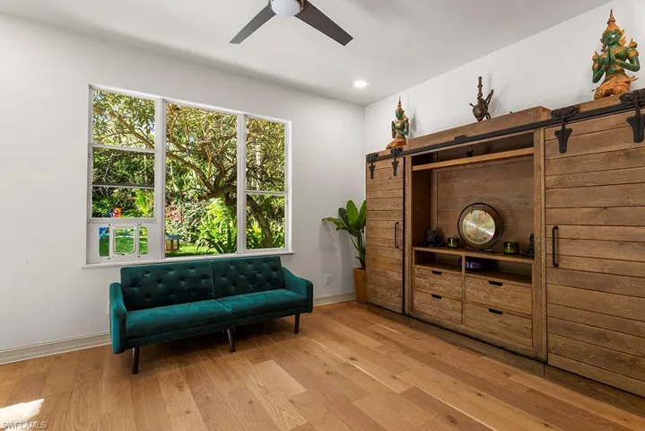 Living area with light wood-style floors, a ceiling fan, and recessed lighting