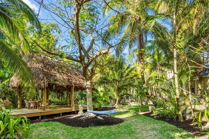 View of green lawn featuring a deck