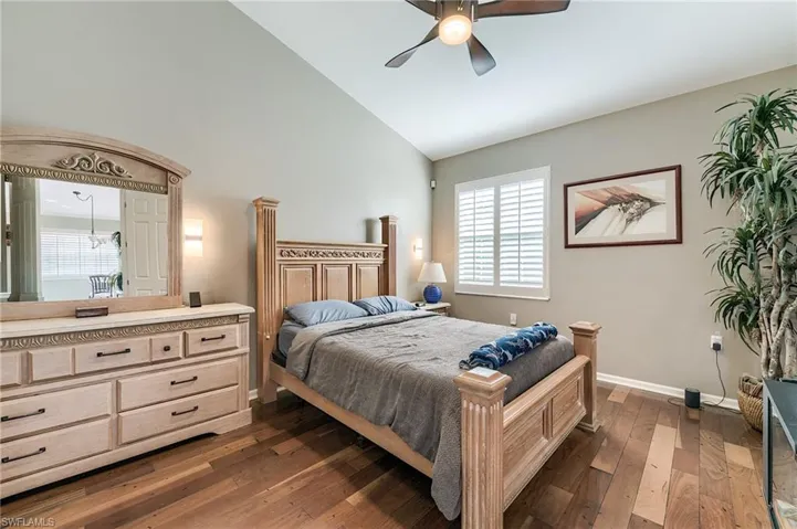 Primary bedroom with wood flooring
