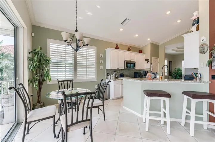 Open kitchen to casual eat-in kitchen dining area and lanai