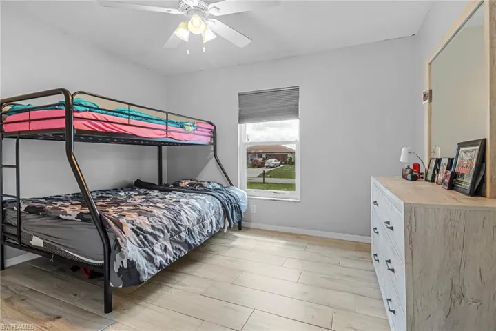 Bedroom featuring light hardwood / wood-style floors and ceiling fan