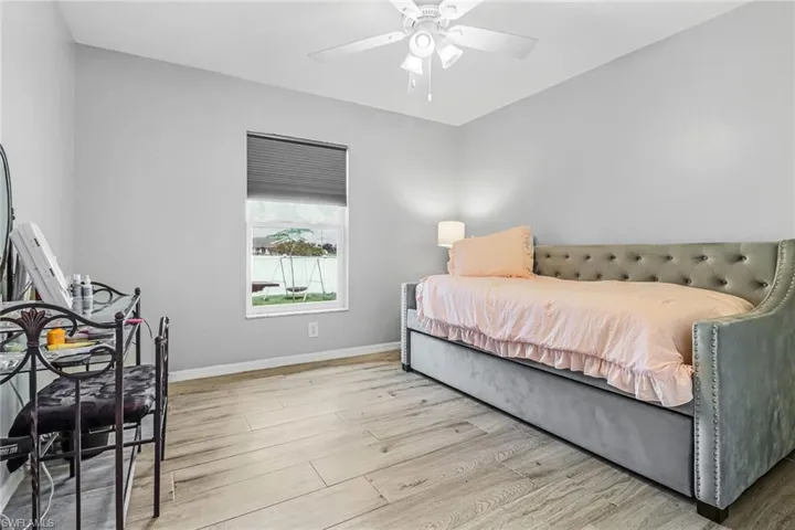 Bedroom with ceiling fan and light hardwood / wood-style flooring