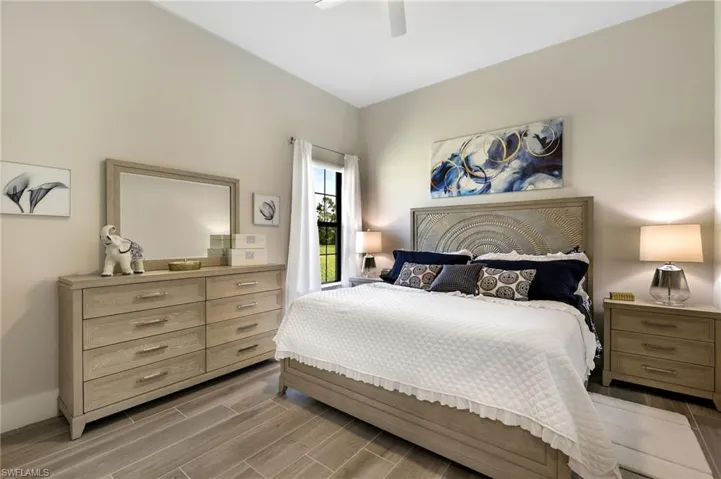 Bedroom with ceiling fan and hardwood / wood-style floors