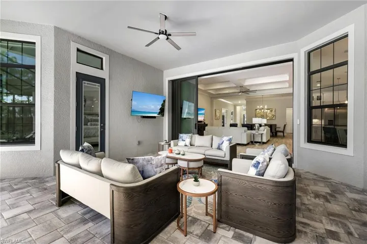 View of patio with ceiling fan and an outdoor hangout area