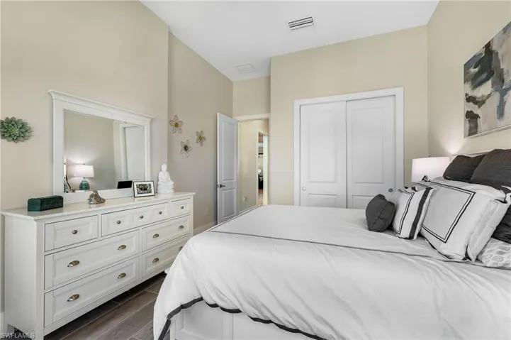 Bedroom featuring dark wood-type flooring and a closet