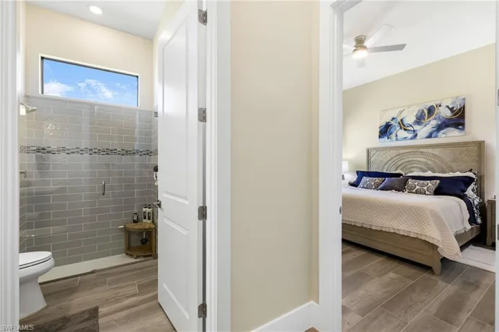 Bedroom featuring ceiling fan and light hardwood / wood-style flooring