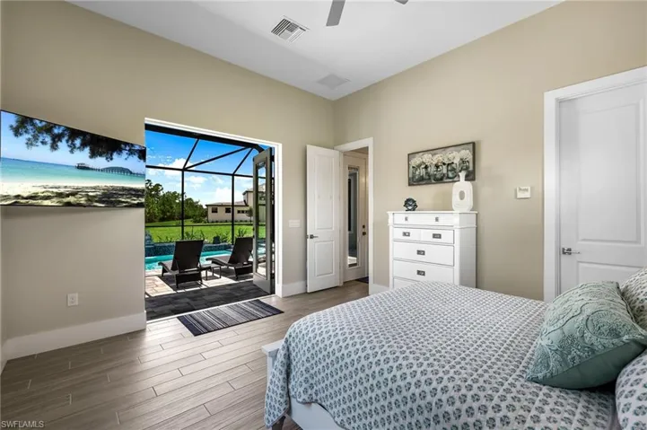 Bedroom with ceiling fan, hardwood / wood-style flooring, and access to exterior
