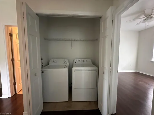 Laundry area with hardwood / wood-style flooring, independent washer and dryer, and ceiling fan