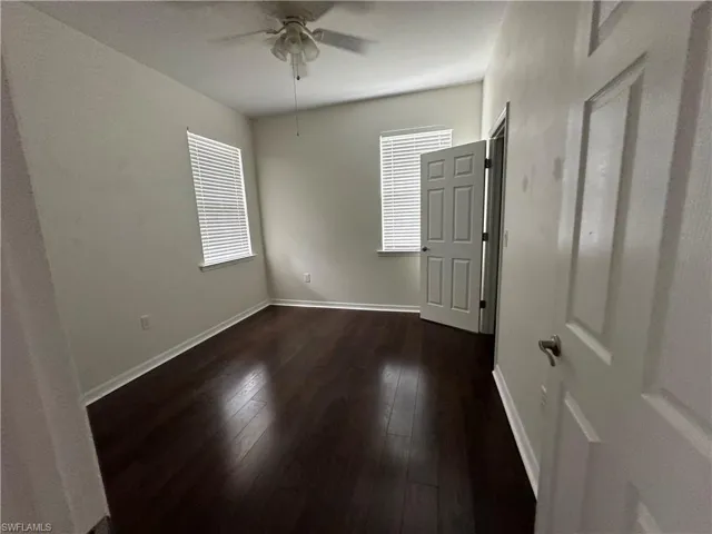 Empty room featuring ceiling fan and hardwood / wood-style flooring