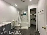 Full bathroom featuring tile patterned flooring, shower / bathing tub combination, toilet, and vanity
