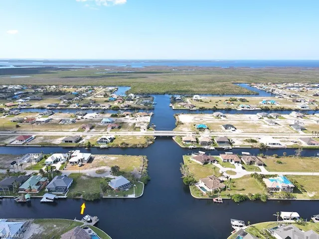 Aerial view of residential area featuring a nearby body of water