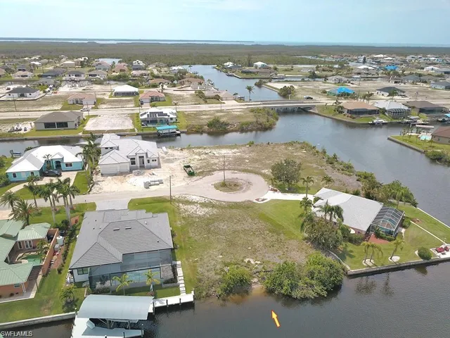 Aerial perspective of suburban area featuring a nearby body of water