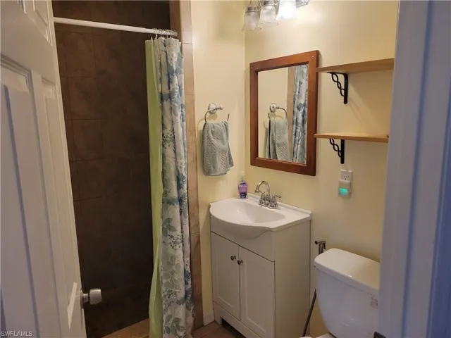 Full bath featuring vanity and a shower stall