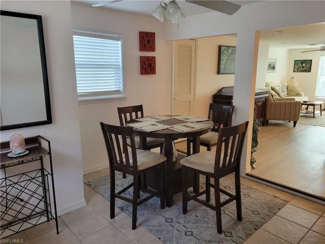 Dining area featuring ceiling fan and light tile patterned flooring