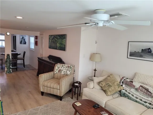Living area featuring light wood-style flooring and ceiling fan