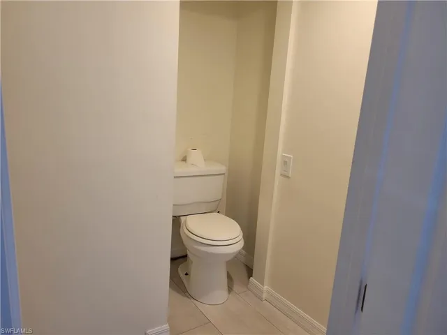 Bathroom featuring toilet and baseboards