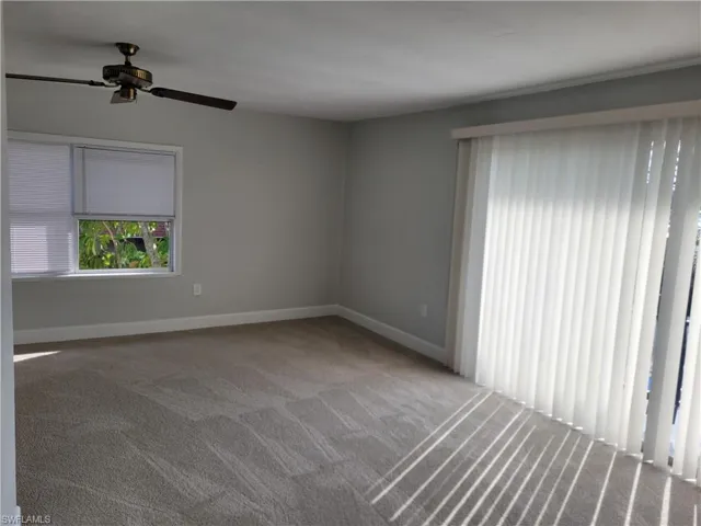 Spare room with light carpet and ceiling fan