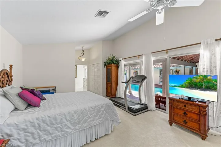 Bedroom featuring carpet floors, access to exterior, and high vaulted ceiling