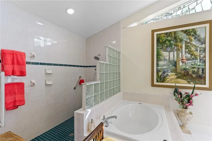 Full bath with walk in shower, a garden tub, and tile patterned flooring