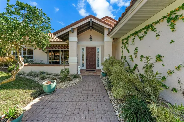 Entrance to property featuring a tiled roof and stucco siding