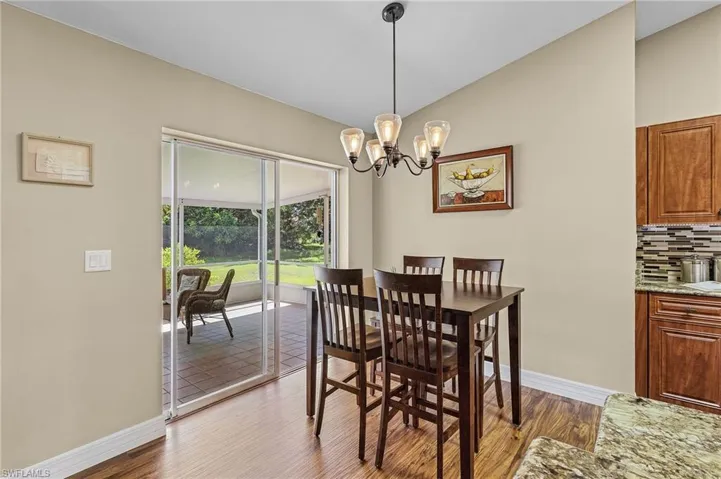 Dining space featuring a notable chandelier and hardwood / wood-style flooring