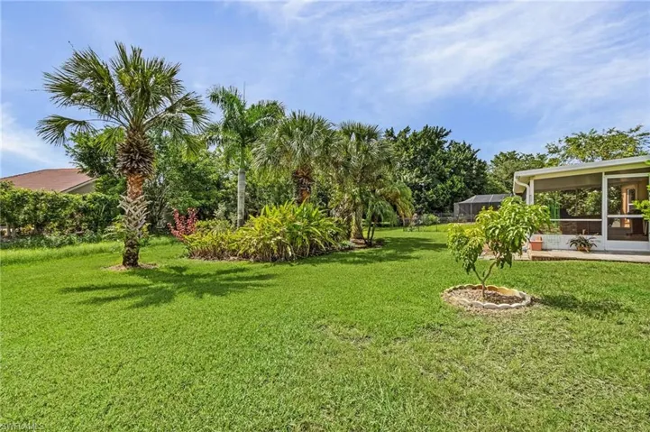 View of back yard with a sunroom