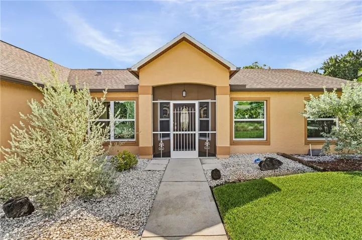 View of exterior entry with a yard