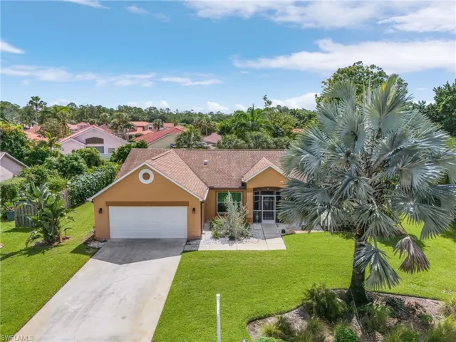 View of front of home with a front lawn and a garage