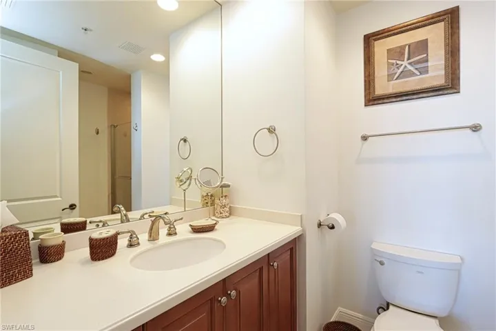 Bathroom with vanity, toilet, and walk in shower
