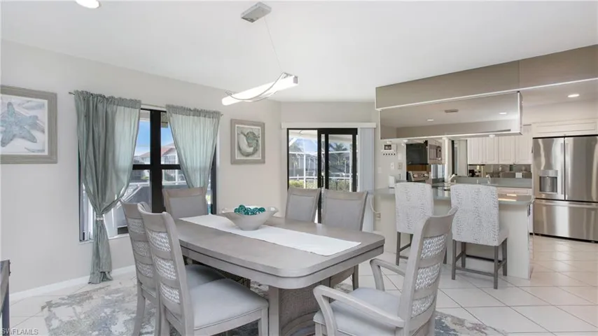 Tiled dining room featuring french doors