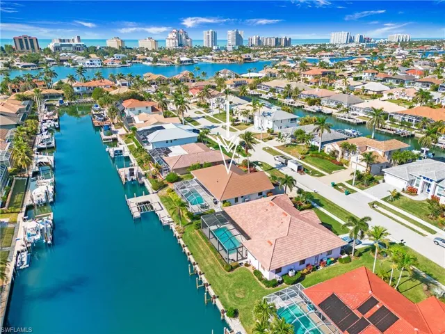 Birds eye view of property with a water view