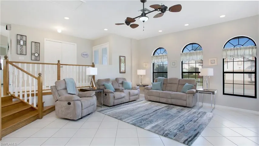 Tiled living room featuring ceiling fan