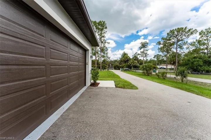 Garage featuring driveway