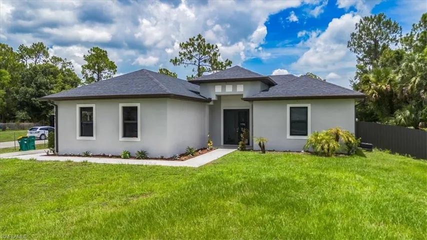 Prairie-style home with stucco siding and roof with shingles