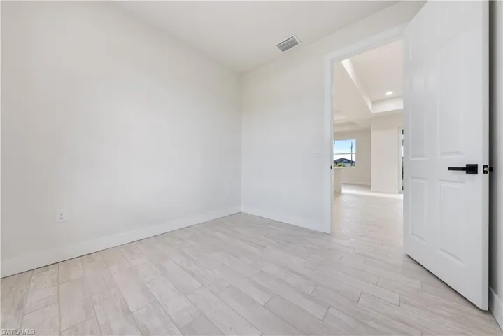 Unfurnished room with light wood-style flooring and recessed lighting