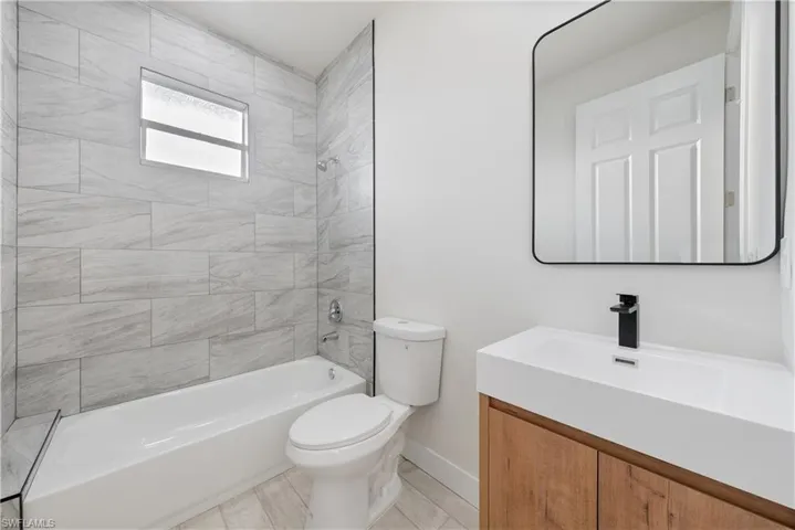 Bathroom with vanity and  shower combination