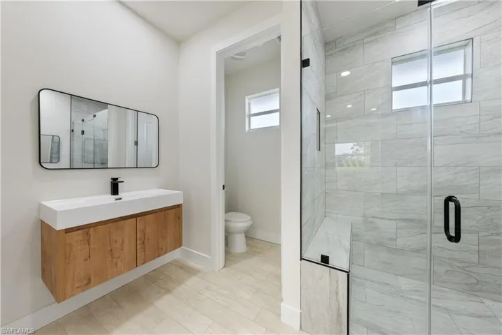Bathroom featuring a stall shower and vanity