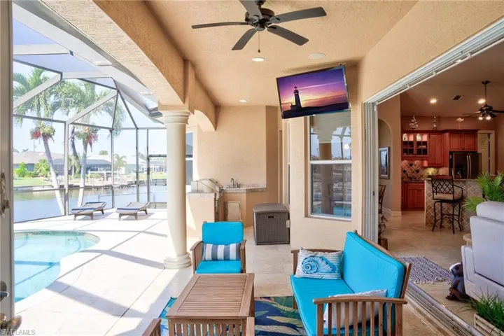 View of patio / terrace featuring outdoor lounge area, a lanai, an outdoor pool, and ceiling fan