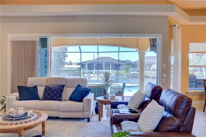 “Spacious Open Living Area with Canal Views”Relax in this airy living room featuring high ceilings and a direct line of sight to the water.