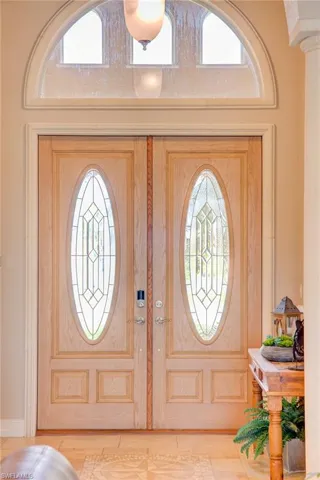 “Grand Entry with Natural Light and Elegant Design”Step into a bright and welcoming foyer with transom windows and sleek tile flooring.