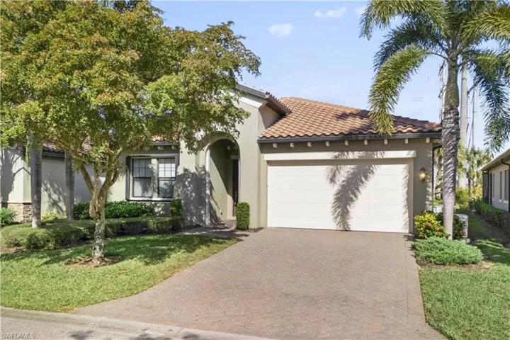 Inviting entryway with lush tropical landscaping and charming curb appeal.