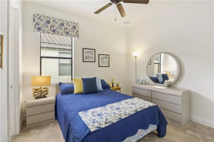 Bright guest bedroom with ample closet space and natural light, perfect for family or visitors.