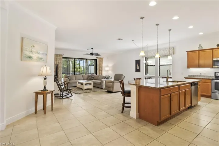 Bright family room seamlessly connected to dining and kitchen spaces for modern living.