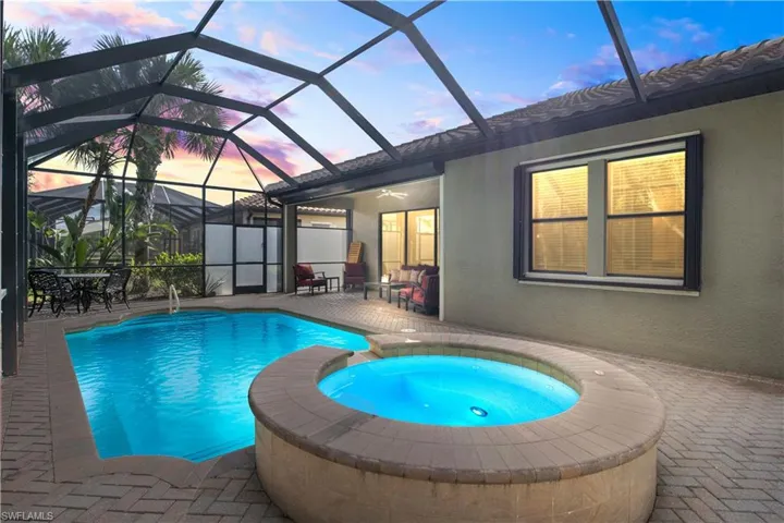 Enjoy Florida sunsets from the lanai overlooking the pool and spa, a picturesque setting for quiet nights or gatherings.