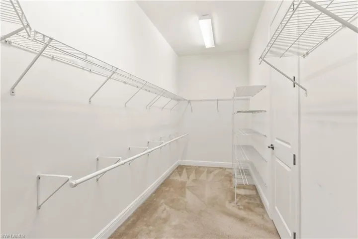 Generously sized walk-in closet designed for functionality and easy organization.